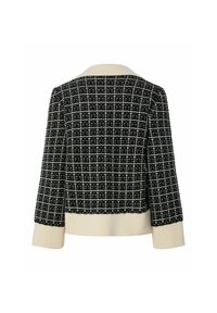 Svart- och vitmönstrad kortjacka med en ribbad krämfärgad krage och ärmslut. Strukturerad design med ett rutmönster och mjuk textur.