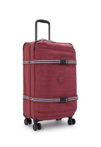 Red fabric suitcase with a textured finish, black handle, four wheels, and contrasting straps. Round logo detail on front.