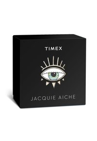 Schwarze Box mit geometrischem Augendesign, das eine Iris in Grün und Blau zeigt, umgeben von Stacheln. Text: "TIMEX" und "JACQUIE AICHE" in Weiß.