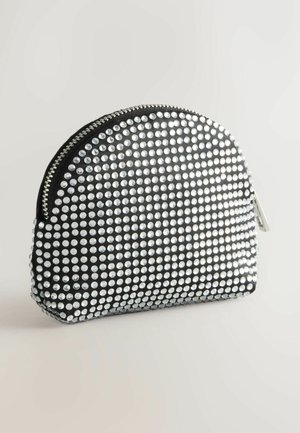 Černý sáček s kulatým vrchem, zdobený stříbrnými rhinestones. Obsahuje černý zip a hladký texturovaný povrch.