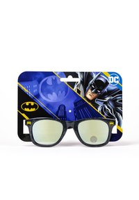 Batman-themed sunglasses with a black patterned frame and green mirrored lenses, displayed on a blue card featuring Batman graphics.