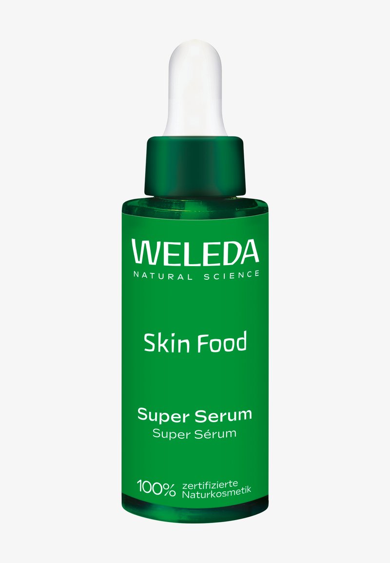 Bouteille compte-gouttes en verre vert étiquetée Weleda Skin Food Super Serum avec du texte blanc, conçue pour les soins de la peau naturels.