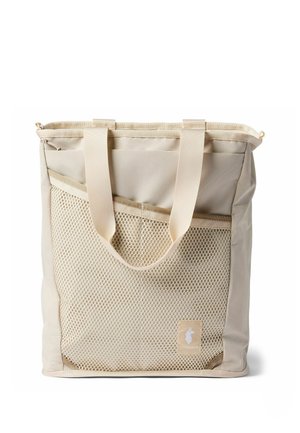 Beige tote bag with two handles and a large front mesh pocket, featuring a small label with a white animal silhouette.