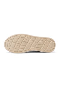 Suola della scarpa in un materiale gommoso beige chiaro, caratterizzata da un motivo di grip testurizzato e forme geometriche rialzate per una maggiore aderenza.