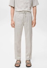 Light grey trousers with a relaxed fit, elastic waistband, and drawstring. Smooth fabric with vertical seams and no visible patterns.