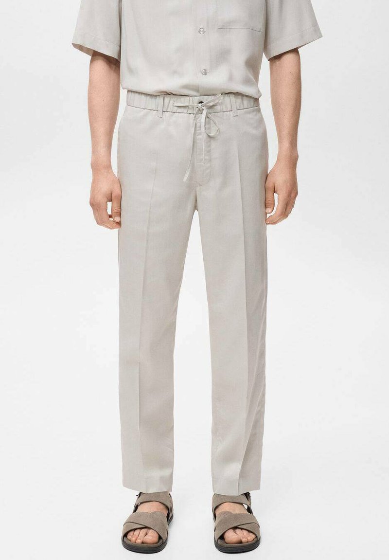 Light grey trousers with a relaxed fit, elastic waistband, and drawstring. Smooth fabric with vertical seams and no visible patterns.