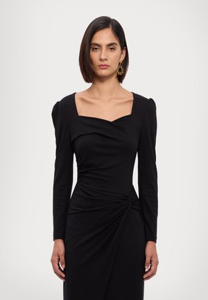 Schwarzes langärmliges Kleid mit quadratischem Ausschnitt, gerafftem Vorderteil und gedrehtem Detail in der Taille. Glatter Stoff mit taillierter Silhouette.
