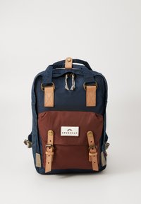 Navy and brown backpack with leather accents, adjustable straps, two front pockets with buckles, and a top handle. Durable fabric construction.