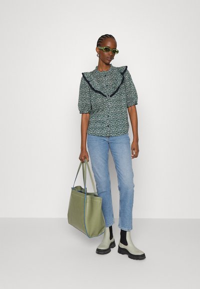 Πράσινη λουλουδάτη μπλούζα με ριγωτό ναυτικό γιακά, συνδυασμένη με ανοιχτό μπλε τζιν, πράσινη τσάντα ώμου και γκρι-πράσινα μποτάκια μέχρι τον αστράγαλο με μαύρες σόλες.