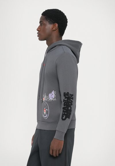Gray sweatshirt with a hood, featuring printed designs on the front and sleeve, including "Charlie Brown" and cartoon characters. Soft fabric texture.