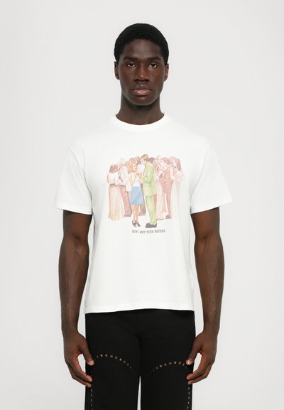 White cotton t-shirt featuring a colorful graphic print of people, with the text "HOW I MET YOUR FATHER" in the center. Crew neckline.
