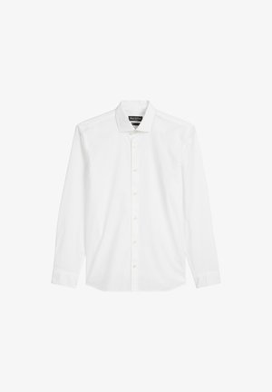 Biała, długa koszula z długim rękawem zapinana na guziki, wykonana z bawełny. Posiada klasyczny kołnierzyk, listwę z przodu oraz subtelne logo na piersi.