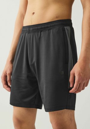 Mustad mustreifeniga athletic lühikesed püksid, küljetaskud ja sile, kerge tekstuur. Esiküljel on väike logo.