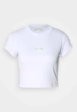 T-shirt blanc court avec un col rond et des manches courtes, arborant un discret logo "Calvin Klein" au centre.