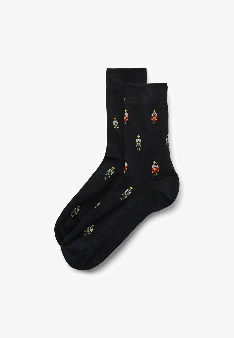 Calze blu navy con motivo ripetuto di schiaccianoci in rosso, giallo e verde. Texture liscia, altezza standard alla caviglia e punta rinforzata.