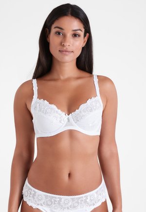 White lace bra with floral embroidery, underwire support, adjustable straps, and scalloped edges. Accompanied by matching white lace panties.