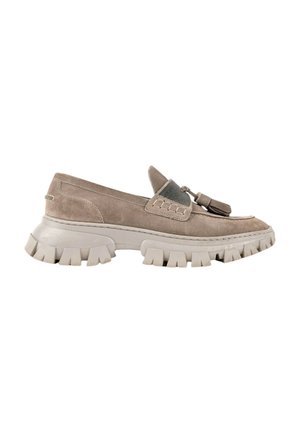 Beige suede loafer with chunky lug sole, tassel detail on front, and elastic band across top for a secure fit.