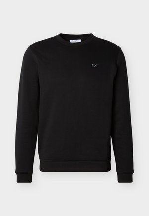 Sudadera negra de manga larga con cuello redondo y pequeño logo "ck" blanco bordado en el pecho izquierdo, puños y dobladillo acanalados.