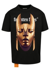 Camiseta de algodón negra que presenta un gran gráfico dorado de una cara inspirada en el antiguo Egipto con cuernos, adornada con pendientes y texto arriba.