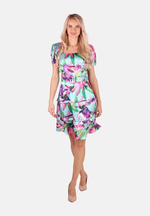 Floral print dress in turquoise, featuring puff sleeves, a fitted bodice, and tiered ruffles at the hem. Includes a matching belt.