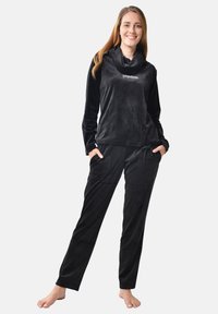 Black velour loungewear set featuring a cowl neck top and drawstring pants, both with a soft texture and side pockets.