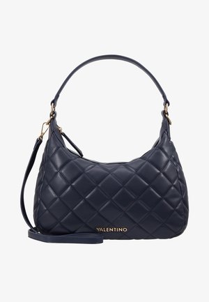 Marineblauwe gewatteerde leren handtas met een enkele schouderband en gouden hardware. Kenmerkt zich door een opvallende merknaam in het goud aan de voorkant.