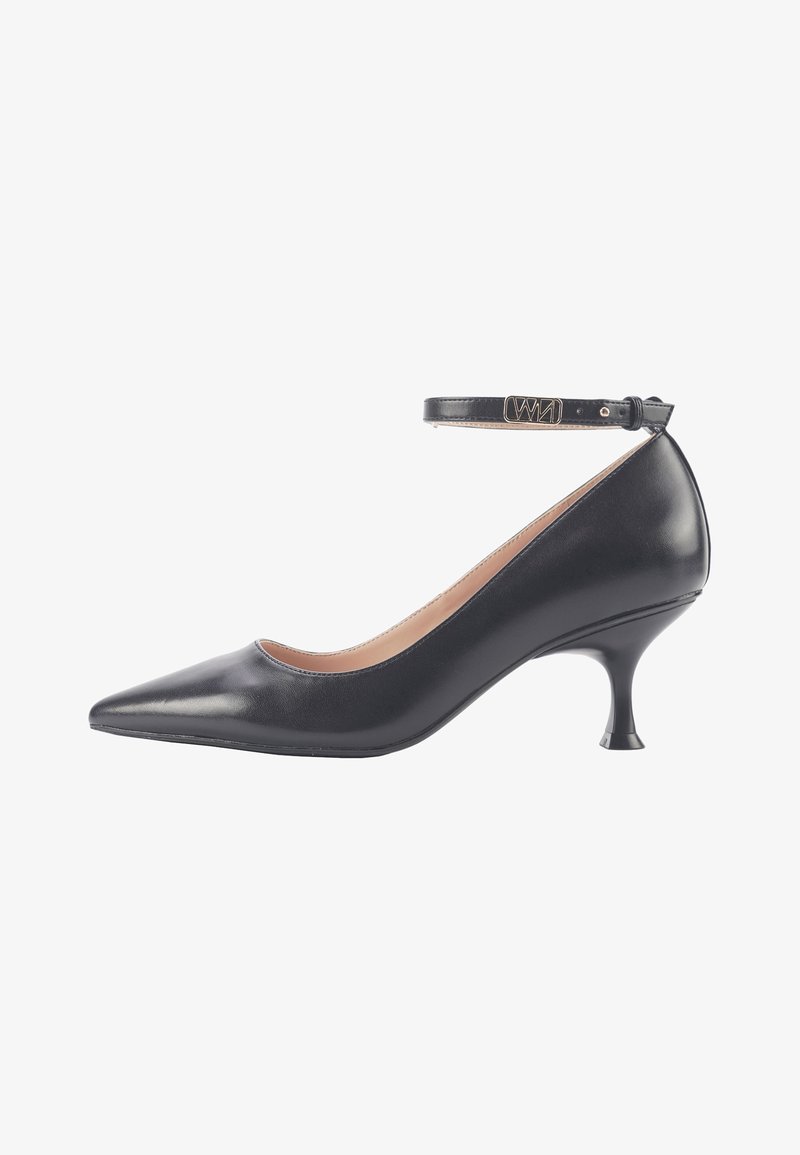 Black leather high-heeled pump with a pointed toe, ankle strap, and a flared heel. Smooth texture with a polished finish.