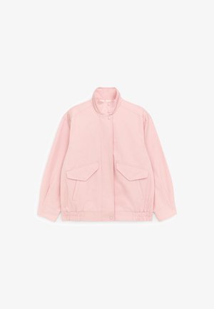 Light pink jacket with high collar, front snap button closure, two flap pockets, and elasticized hem and cuffs.