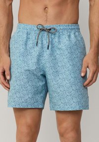 Costumi da bagno azzurri chiari con motivo a foglie, vita elastica con coulisse e una texture del tessuto liscia.