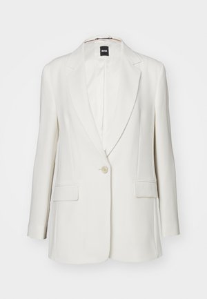 White blazer featuring notched lapels, a single button closure, two front pockets, and smooth fabric with a structured silhouette.