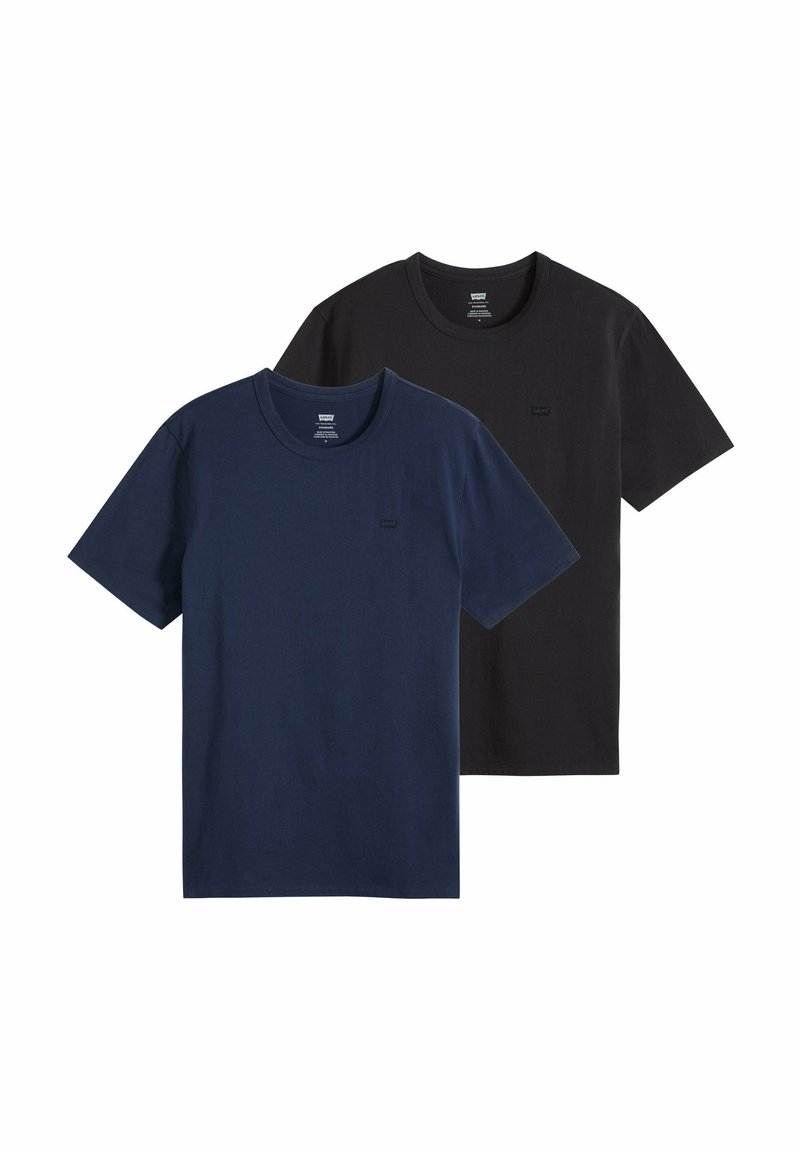 Dos camisetas básicas de cuello redondo, una azul marino y otra negra, mostradas planas con mangas cortas y pequeño logo en el pecho.