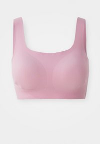 Light pink wireless sports bra with wide straps and seamless molded cups, designed for comfort and support.