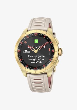 Smartwatch con cassa dorata e cinturino beige che mostra un messaggio WhatsApp: "Partita stasera dopo il lavoro?" e lancette analogiche.