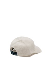 White fabric cap with a structured shape, featuring a flat brim and a textured surface. Includes a black and green striped adjustable strap.