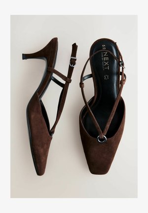 Pruun seemisnahast kõrvarihmaga kontsakingad, millel on terav nina, ristikujulised rihmad ja väike pandla detail. Tall on must ja lame.