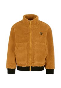 Veste en polaire orange avec un col montant, fermeture éclair à l'avant, deux grandes poches plaquées, et des poignets et un ourlet en bord-côte noir. Présente un logo sur la poitrine.