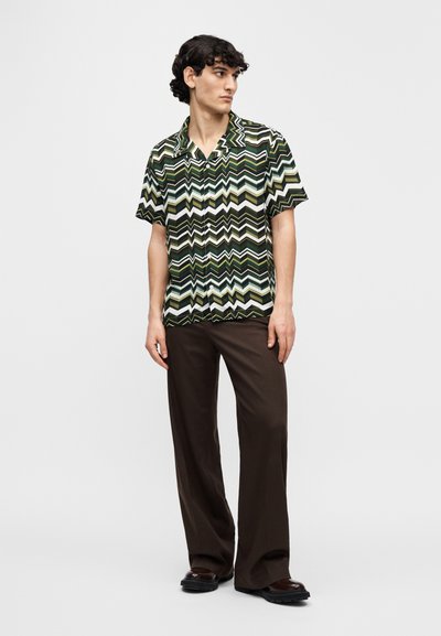 Κοντομάνικο πουκάμισο σε μαύρο, πράσινο και κρεμ μοτίβο ζιγκ ζαγκ· καφέ παντελόνι· λείο ύφασμα· άνετη γραμμή. Καθημερινό σχέδιο με κουμπιά στο μπροστινό μέρος.