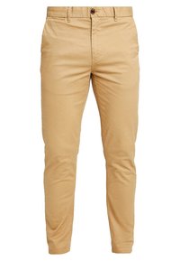 Beige bomulds chinos med slim fit, der har en knaplukning, bæltestropper og sidelommer. Glat tekstur og minimalistiske detaljer.