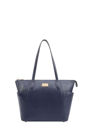 Navy blue leather tote bag with dual handles, zip closure, and a front pocket. Features a metal logo plate on the side. Smooth texture.