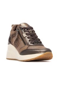 Brown wedge sneakers with mesh and leather panels, featuring a front zipper, textured accents, and a gum rubber sole.