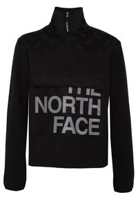 Felpa nera con colletto alto, chiusura con zip e grande tasca frontale con il logo "THE NORTH FACE" in materiale a rete bianca.