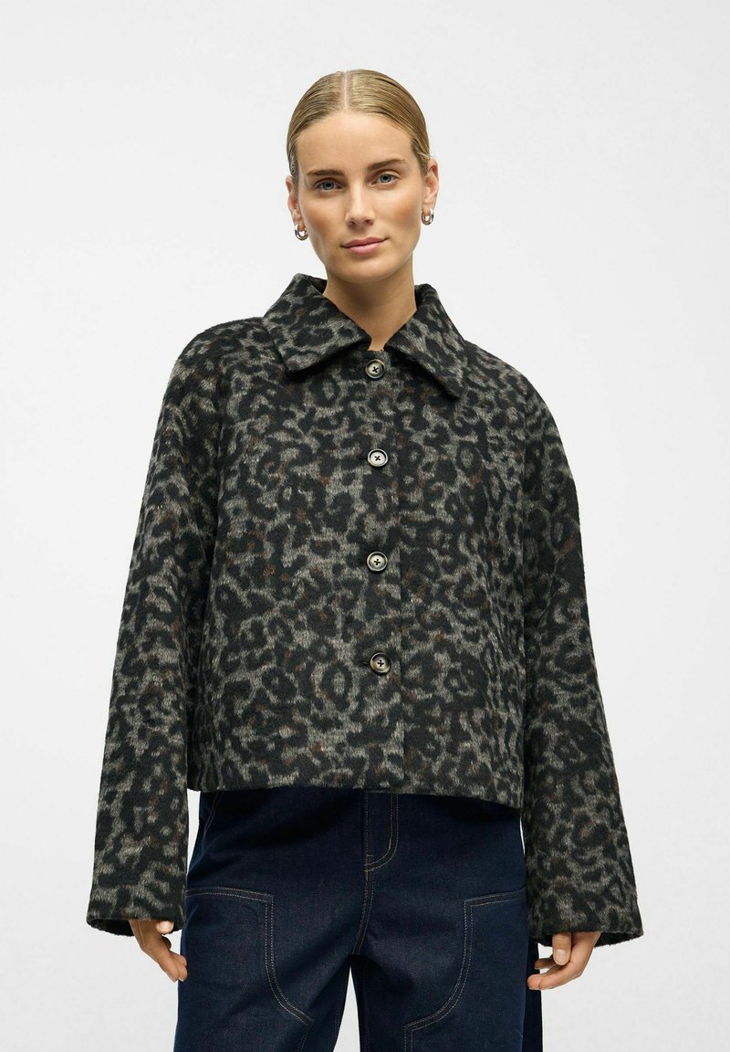 Cropped leopard print jacket in dark tones, featuring a wide collar, long sleeves, and large buttons with a textured fabric finish.