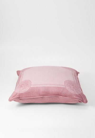 Square, pink pillow with a textured surface, featuring a subtle pattern and rounded corners. Accented with a decorative border design.