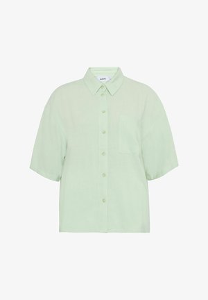 Short-sleeve, collared shirt in light green, featuring a button-down front and a chest pocket. Fabric appears smooth with a slight texture.