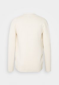 Cremfarbener, langärmeliger, gerippter Pullover mit Rundhalsausschnitt, flach von hinten auf einem weißen Hintergrund präsentiert.