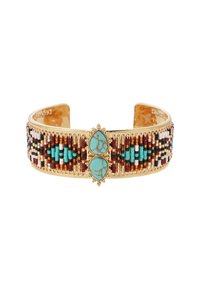Bracelet en bracelet en or avec des perles multicolores en turquoise, rouge, noir et blanc, avec deux accents turquoise en forme de goutte.