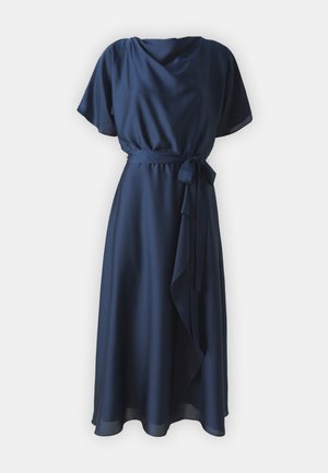 Sötétkék ruha sima anyagból, rövid fodros ujjakkal, derékra csatolt övvel és aszimmetrikus szegélyű, lebegő szoknyával.