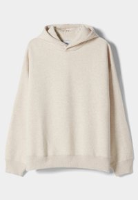 Ljus beige hoodie gjord av en mjuk bomullsblandning, med en stor framficka, ribbade ärmslut och en dragsko till huva. Lätt och ledig passform.