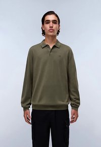 Olive green long-sleeve polo shirt with a collar, featuring a small emblem on the chest and ribbed cuffs at the wrist and hem.