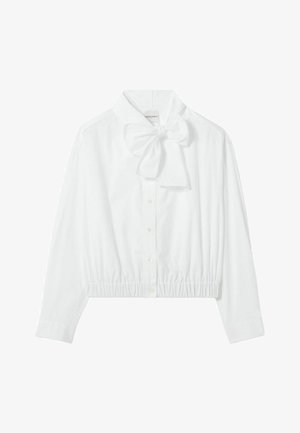 Blusa blanca corta con lazo en el cuello, cierre de botones y dobladillo fruncido. Hecha de una tela lisa y ligera.